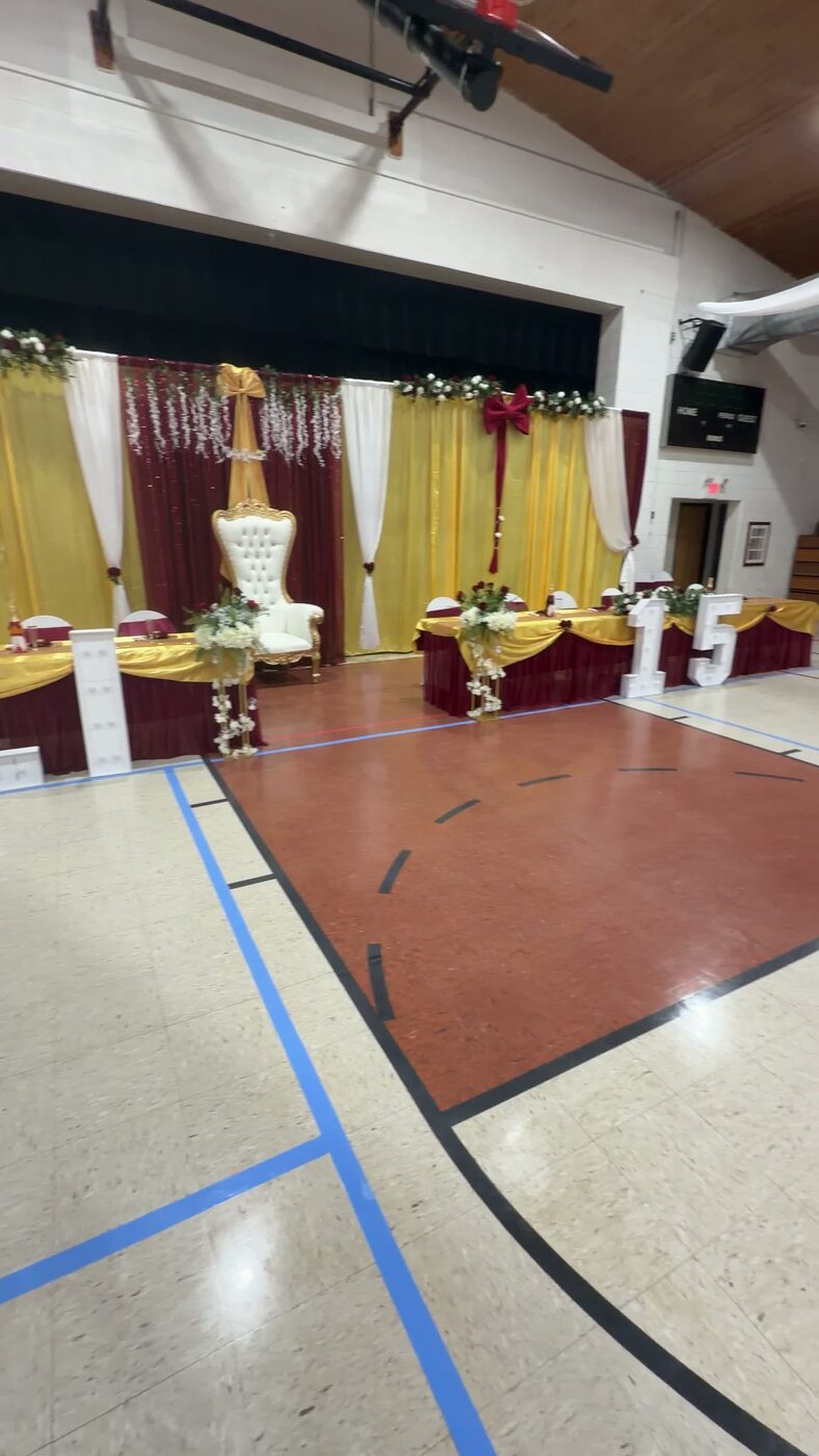 White throne chair and marquee numbers at a quinceañera